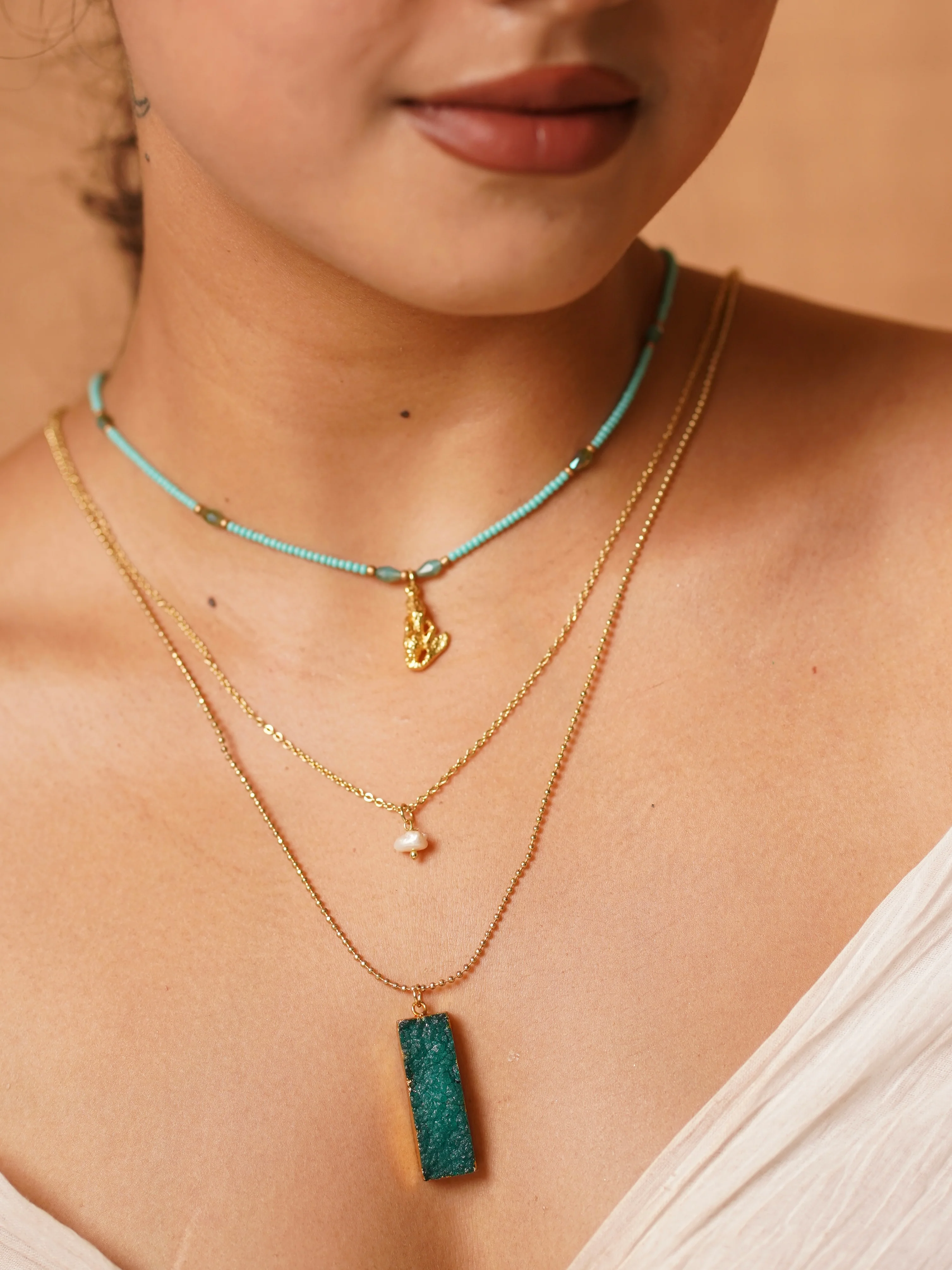 Symphony in layers—turquoise, pearl, and raw stone charm.